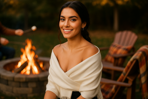 AI Model : Olive skin, straight dark hair in a loose braid, wearing FURTALK pashmina, relaxing by a crackling backyard fire pit, friends roasting marshmallows, cozy autumn blankets draped across Adirondack chairs.
