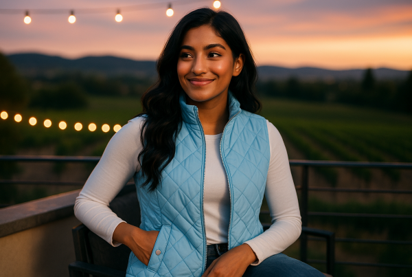 AI Model : A 22-year-old South Asian woman with long, jet-black waves relaxes on a rooftop terrace overlooking a vineyard, string lights twinkling at dusk.